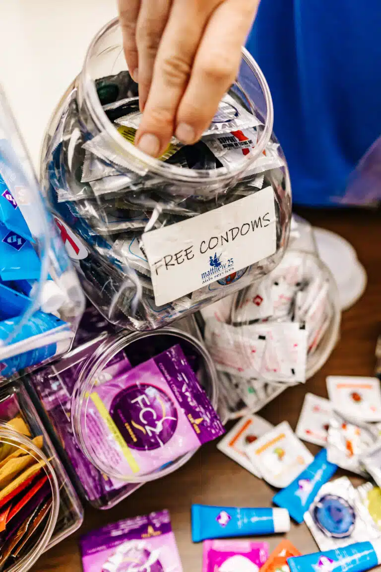 Hand reaching for free Matthew 25 condoms