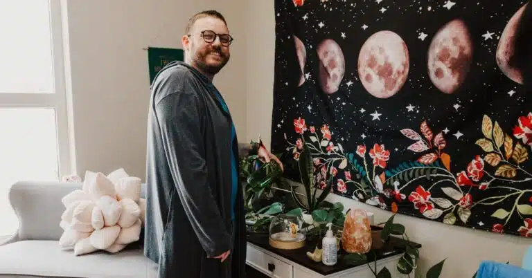man smiling near plants