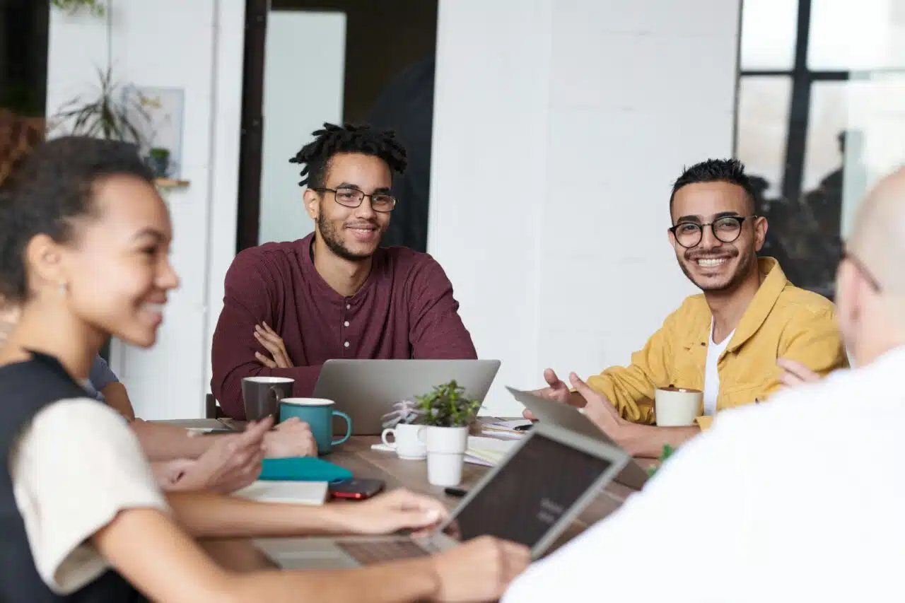 Diverse group of people at table smiling